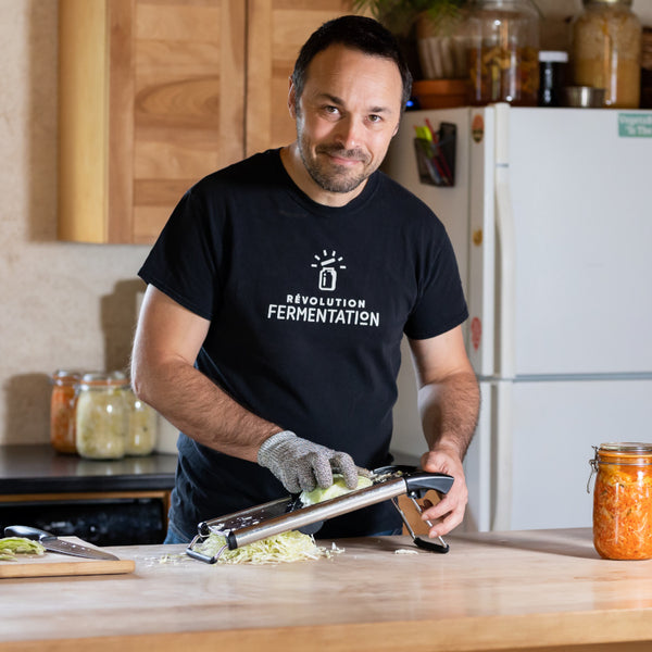 making sauerkraut using mandoline slicer and safe gloves