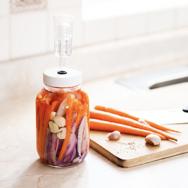 Mason jar with a fitted lid and fermented vegetables